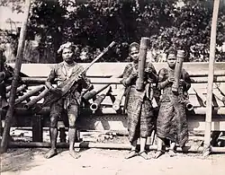 Philippines. Bagabo musicians exhibited at the Louisiana Purchase Exposition in St. Louis, 1904. The girls hold tube zithers [possibly saluray], and the man holds a kutiyapi lute.