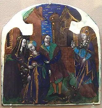 An enamel of Lupus of Troyes, a 5th-century bishop, healing a deaf woman. The old Cathedral is visible in the background.
