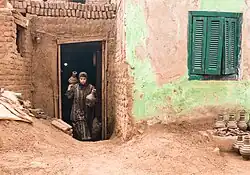 An Egyptian woman carrying clay pots
