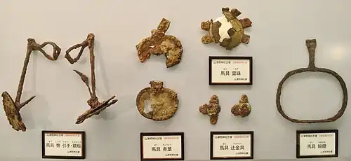 Kutsuwa bit and kagami-ita cheekpieces, gyōyō and uzu decorations, and wa-abumi ring stirrup, from Yamatsuteru Jinja Kofun [ja], Shiga Prefecture (Shiga Prefectural Azuchi Castle Archaeological Museum [ja])