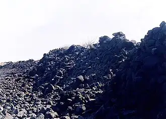 Piled stones, showing a dilapidated section of the wall