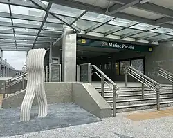 A statue in front of an underground train station exit