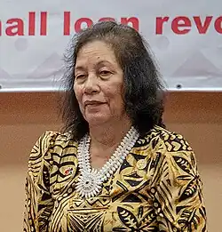 A woman with shoulder length black hair wearing a patterned dress