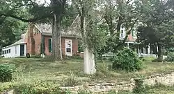 "Cedar Grove" (Amick-Kingsbury House). The smaller one-story Federal section dating from about 1825 is to the left; the two-story Greek Revivial section dating to 1856 is to the right. Later additions can be seen behind the Federal section. The house is still used as a residence.