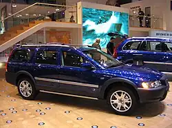 Passenger side view of blue XC70 OR with silver door trim, rocker trim and roof rails