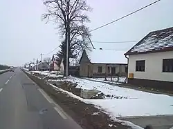 Samatovci during the winter with on a road overlooking a long line of houses covered with snow