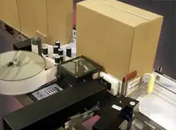 Label printer applicator applying a label to adjacent panels of a corrugated box