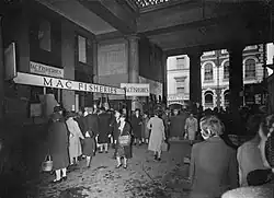 Image 33The Higher Market, Exeter, in 1943; at this time the larger firms such as Mac Fisheries had joined the smaller shopkeepers' stalls in the market, which, before the war, along with neighbouring Goldsmith Street, was earmarked for demolition; a new Civic Centre was to be built on the site. (from Exeter)
