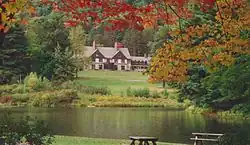 The Allegany State Park Administration Building as seen from the Red House Picnic Area across Red House Lake.