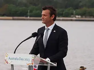 A man in a black suit.