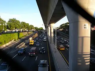 A concrete AirTrain viaduct over Van Wyck Expressway