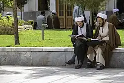 Two seminary students debating in the Fayziyeh School of Qom