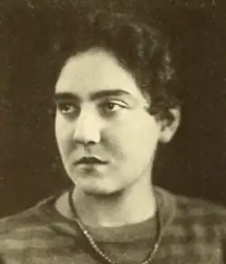 A young white woman with dark hair and dark eyes