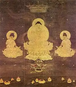 Frontal view of a deity seated on a pedestal framed by two seated attendants.