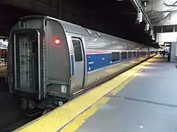 A row of stainless steel cars at a station