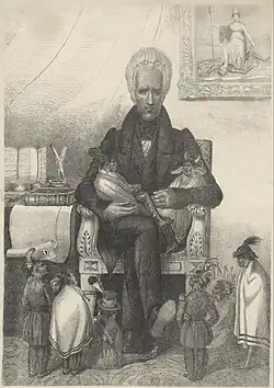 "Andrew Jackson as the Great Father" —In this political cartoon, likely published in the 1830s, Andrew Jackson sits in an armchair holding two diminutive Native Americans on his lap. Six diminutive Native Americans sit or stand on the patterned rug at Jackson's feet, looking up at him.