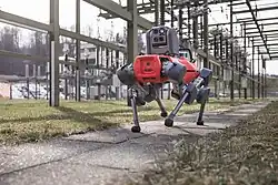 An ANYmal D is walking around in a substation to do visual, thermal, and acoustic inspections daily to ensure asset health.