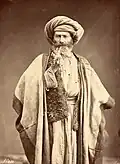 Arab man smoking pipe, late 1800s
