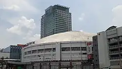 The Red Gate facade Araneta Coliseum in 2018, with the construction of the Gateway Mall 2 in the foreground and the Gateway Mall and Gateway Tower at the background
