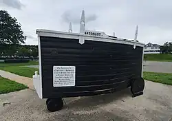 A wooden three-wheeled submarine replica.