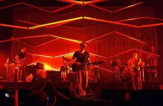 Atoms for Peace performing in 2010. From left: Nigel Godrich, Thom Yorke, Joey Waronker (behind Yorke), Flea, Mauro Refosco