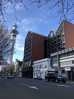 Auckland City Mission's HomeGround building, seen with St Matthew's church and the Sky Tower, 2022.