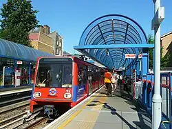 Red Docklands Light Railway train at a station