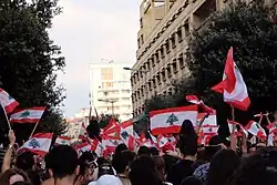 Protestors flying Lebanese flags during the 17 October Revolution in Beirut