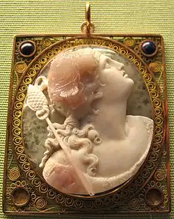 Pink and white stone cameo of a woman looking up and to the right