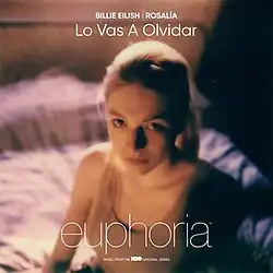 Cover art for "Lo Vas a Olvidar": Jules, a young girl and a character from the American TV show Euphoria, sitting on a bed.