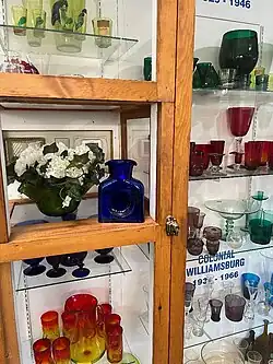Various types of glassware in various colors including blue, red, and green