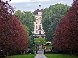 The Alter Hauptbau, seen through the trees from the path to Schloss Favorite