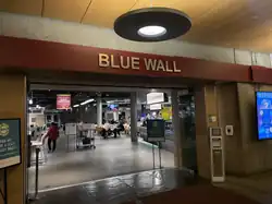 Depicts an entrance to a large dining area with the words "Blue Wall"