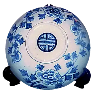 Rice bowl cover decorated with a medallion of the double happiness and longevity (Shou) symbol in the center, from Joseon dynasty Korea