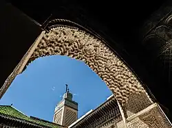 Muqarnas sculpting in the intrados of the archway at the entrance of the lateral chambers