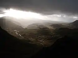Looking south-west from just under Bow Fell summit towards Eskdale under darkening skies