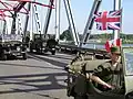 The bridge being crossed by military vehicles