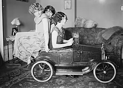 The Brox Sisters, posed with toy car. Left to right: Loryane, Bobbe, Patricia