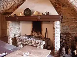 A fireplace in a German castle showing a brick hob.