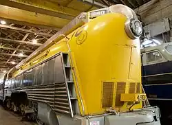 A yellow, streamlined steam locomotive.