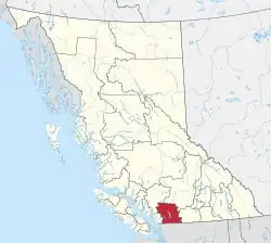 A map of British Columbia depicting its 29 regional districts and equivalent municipalities. One is highlighted in red.