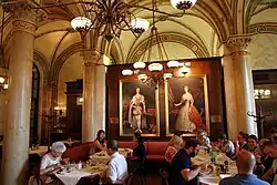 Cafe Central in Vienna interior near portraits of Empress Elisabeth of Austria and Franz Joseph I of Austria