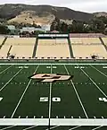 The field at Alex G. Spanos Stadium is shown on the campus of Cal Poly in June 2022, with the university's iconic hillside "P" visible in the background.