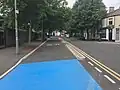 On Senghenydd Road, with blue paint indicating that cyclists have priority over the side junction.