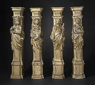 Four plaster columns, depicting women symbolically representing the continents of America, Africa, Europe, and Asia, respectively