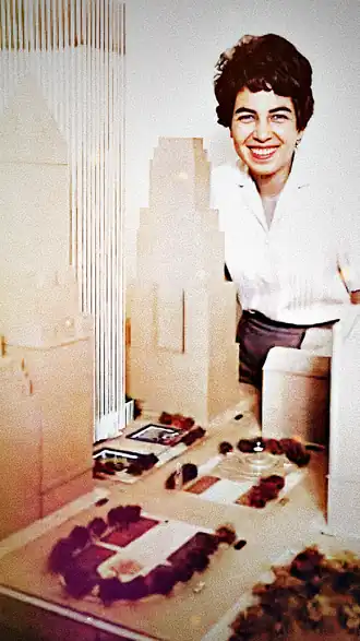 Cecilia Benattar stands beside her 1964 architectural model of the General Motors Building, marking a milestone in her career. The model showcases the iconic skyscraper's design and layout, transitioning her from planning to construction in real estate development. It reflects mid-century architecture's emphasis on large-scale commercial developments shaping Manhattan's skyline. Benattar's presence symbolizes her pioneering role as a woman in finance and business, the developer of Manhattan's General Motors Building.