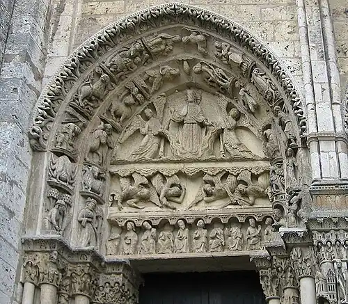 West portal, tympanum of left door. It depicts Christ on a cloud, supported by two angels, above a row of figures representing the labours of the months and signs of the Zodiac[33]