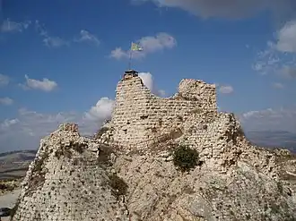 rugged rocky peak with stones and the remains of a tower