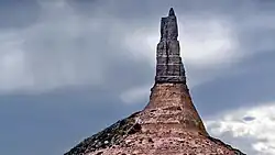 A thin pillar of rock juts upwards.