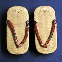 The same pair as adjacent, showing takagawa omote (four-warp woven bamboo-skin topsole; see zōri)